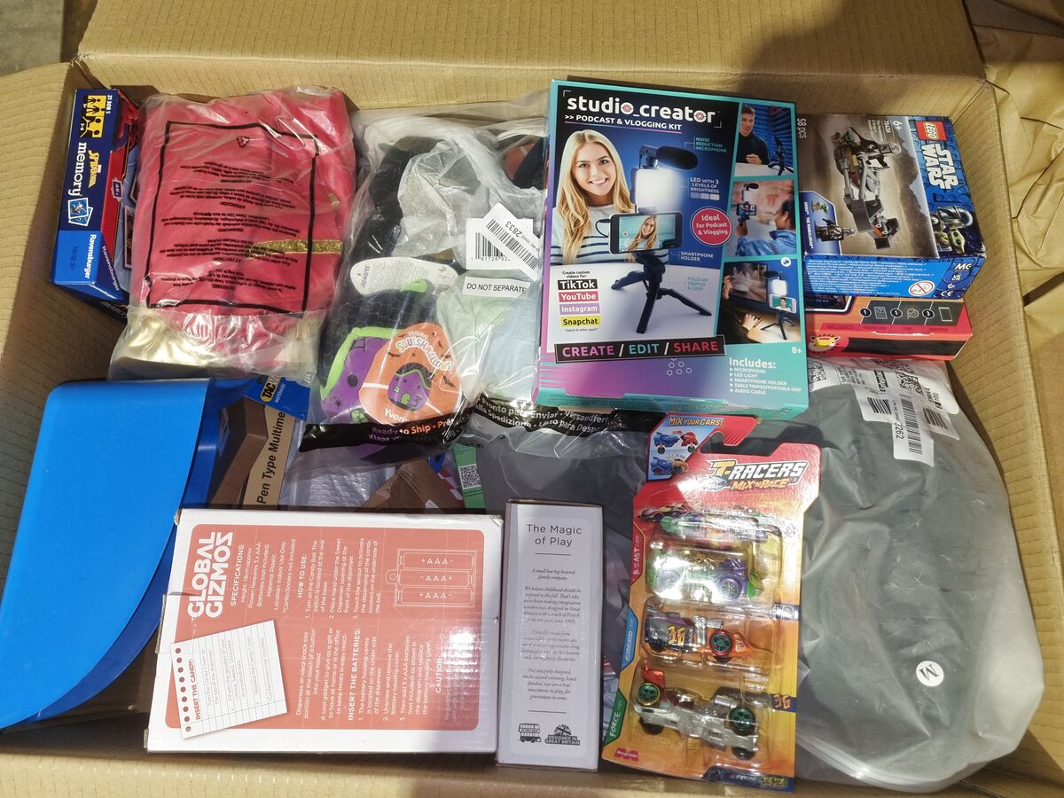 Open StockBee box with a podcast and vlogging kit, LEGO Star Wars set, Squishmallows plush and toy cars